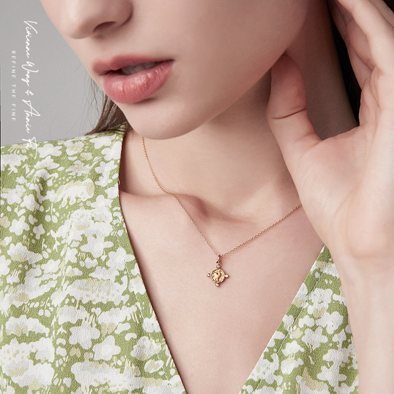 Woman wearing yellow gold heart-shape coin necklace