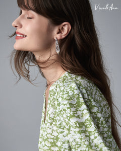 Lady wearing yellow diamond earring