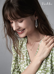 Lady laughing and wearing yellow diamond earring