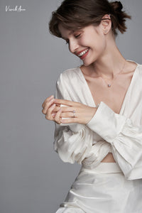 Lady laughing and waring pearl ring and necklace